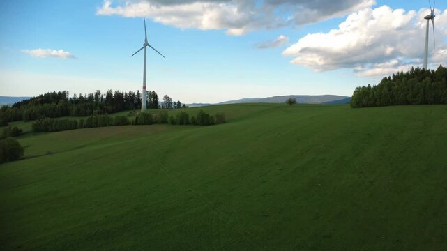 Wind turbines in the Jesen&iacute;ky Mountains near Hanu&scaron;ovice and Doln&iacute; Morava, Czech Republic. Scenic view of renewable energy infrastructure set in a natural mountain landscape with rolling hills, forests