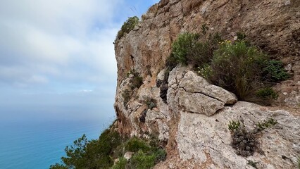 A scenic coastal cliff that offers a vibrant view of the ocean and the surrounding landscape