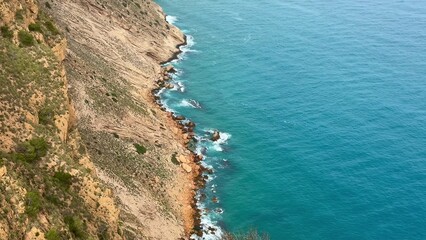 Fototapeta premium Enjoy breathtaking coastal views of rocky shorelines with clear, sparkling blue waters