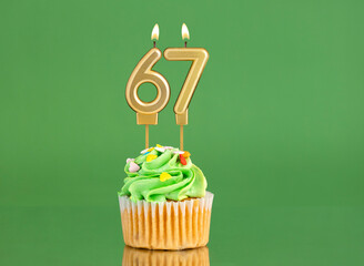 Birthday card with candle and cupcake - Number 67 on a green background
