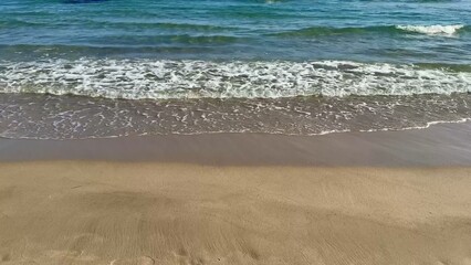 Experience the serene beauty of beach waves crashing gently against the tranquil shoreline