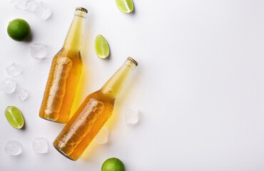 Beer advertisement and evening in pub. Two full transparent glass bottles with ale without labels,...