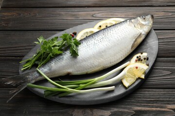 Salted herring and spices on wooden table
