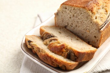 Pieces of banana bread on light grey table, closeup
