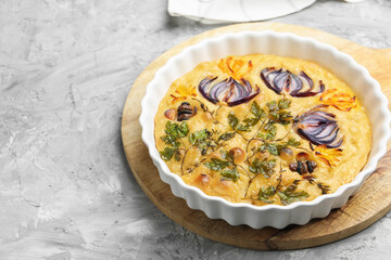 Delicious focaccia with flowers made of vegetables on grey textured table. Space for text