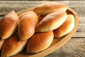 Tasty baked patties on wooden table, closeup