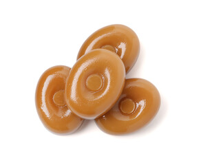 Tasty hard toffee candies isolated on white, top view