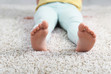 Girl on soft carpet at home, closeup