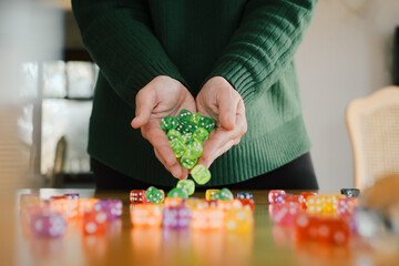 Female Player preparing for session of tabletop game. Dice in woman hands. Table games concept....