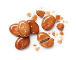 Broken tasty caramel candies isolated on white, top view