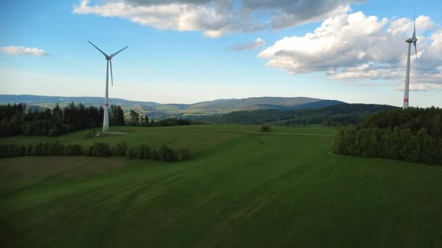 Wind turbines in the Jesen&iacute;ky Mountains near Hanu&scaron;ovice and Doln&iacute; Morava, Czech Republic. Scenic view of renewable energy infrastructure set in a natural mountain landscape with rolling hills, forests