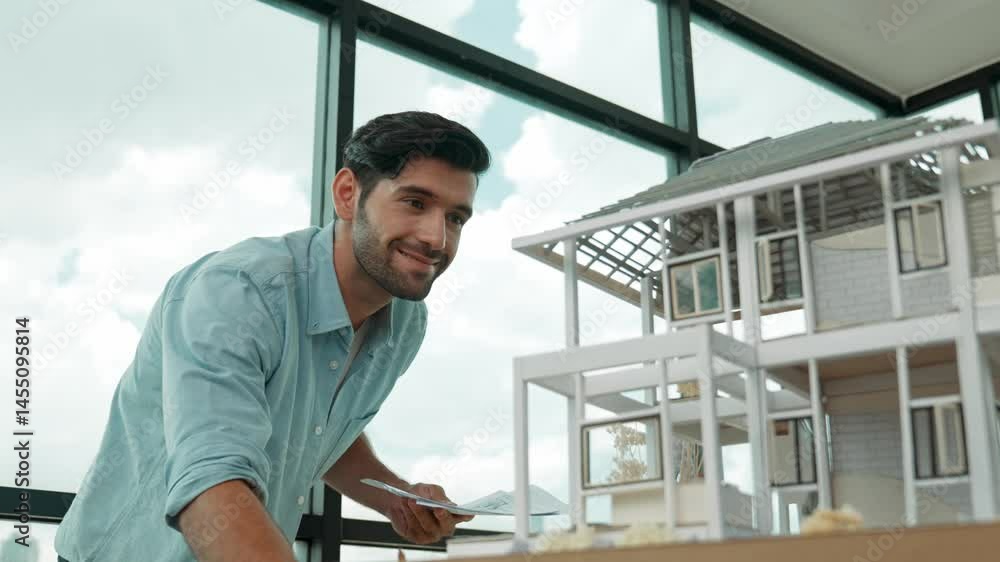Poster professional smart engineer in casual outfit standing while looking at house model. smart project ma