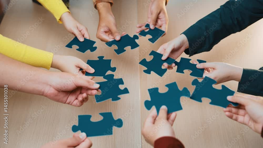 Aufkleber a diverse group of hands collaborates to connect colorful puzzle pieces on a wooden table. this imag