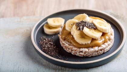 healthy snack with rice cakes banana nut butter and chia seeds