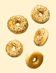 Five pistachio-glazed donuts are artfully arranged on a soft yellow background, combining minimalism and vibrant texture in a bright, high-key food photography composition.