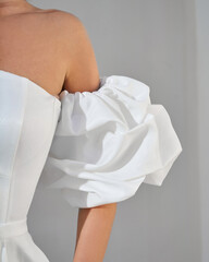 Close-up of White Puffy Sleeve Dress Detail