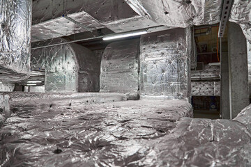 Extensive Network of Insulated Ductwork and Piping for Ventilation and Climate Control Systems within a Building Interior