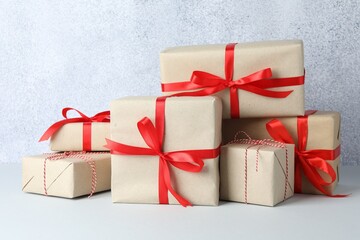 Many gift boxes wrapped in kraft paper on light table