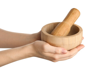 Woman with mortar and pestle on light background, closeup