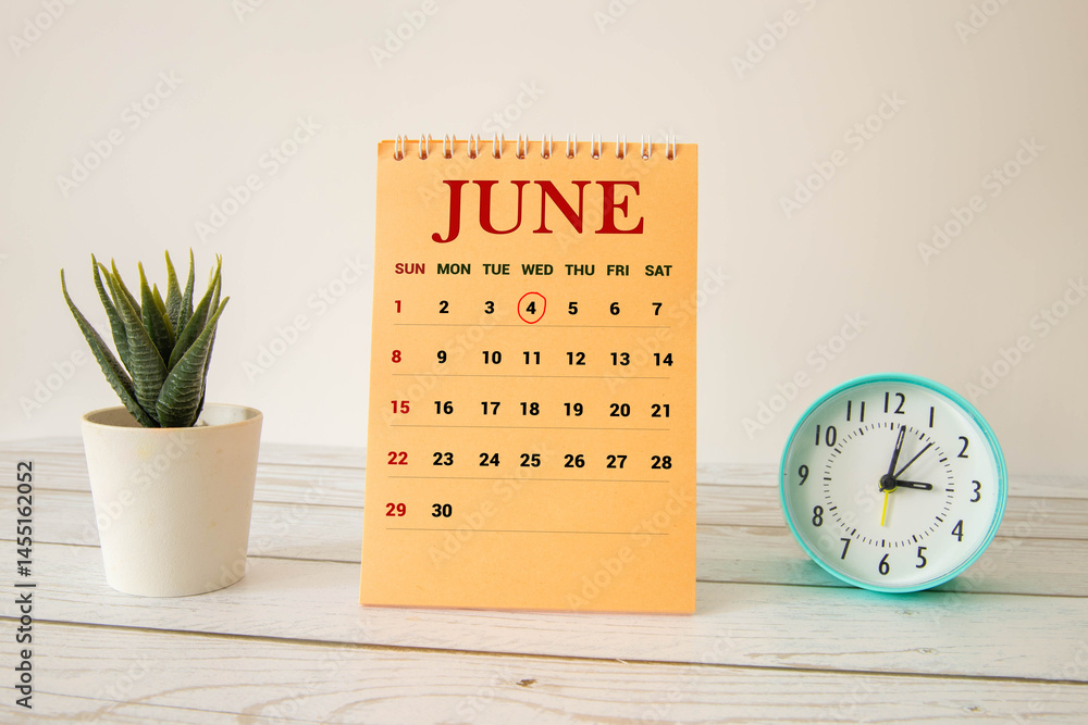 Poster chalkboard with june 04 calendar date on white cube block.