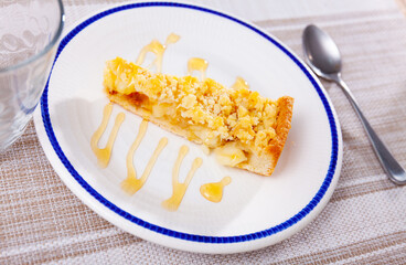 Traditional dessert of European cuisine is an apple pie made from baked dough, fresh apples, eggs and poured with sweet sauce