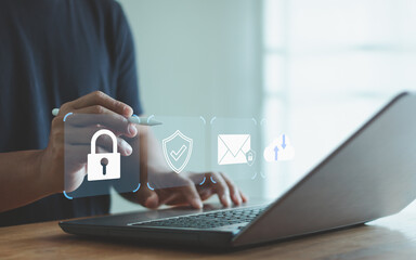 Businessman using laptop with cyber security icon on virtual screen. Cyber insurance, insurance...