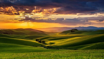 Fototapeta premium serene sunset over rolling green hills and dramatic cloudscape
