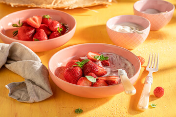 Creamy and delicious strawberries with cream and sugar.