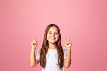 Emotions of happy preschooler. Funny little kid shows two fingers up at copy space, isolated on...