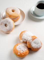 Powdered jelly-filled donuts with creamy fillings on white background – sweet pastry dessert perfect for bakery, breakfast, recipes, articles, snack-theme or any cooking content.