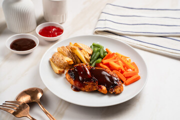 Grilled chicken steak with barbecue sauce, potato wedges, and fresh vegetables. Perfect for healthy lunch, dinner menu content, recipes, articles or any cooking content