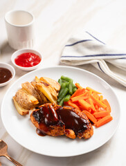 Grilled chicken steak with barbecue sauce, potato wedges, and fresh vegetables. Perfect for healthy lunch, dinner menu content, recipes, articles or any cooking content
