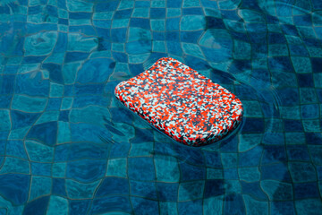Colorful Kids Kickboard Floating in a Pool
