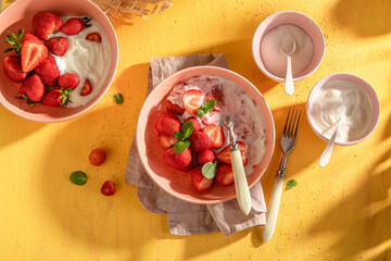 Tasty and homemade strawberries with cream and sugar.