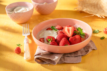 Tasty and creamy strawberries with cream and sugar.