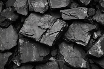 Coal texture background with irregular black shiny chunks in close view