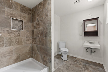 A bathroom that includes a toilet, sink, and a shower area as well