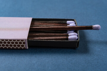 angle view lilac matchbox on a blue background at horizontal composition