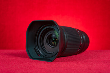 a camera lens on a red background at horizontal composition