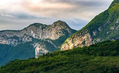 Mountain Landscapes with Forested Hills and Atmospheric Skies