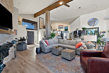 A spacious living room with a large couch and flat screen TV