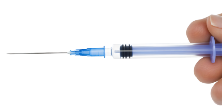 Close-Up Of Hand Holding Syringe With Needle Against Black Background Photo