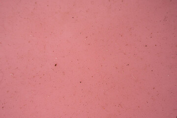 Soft pink textured background with subtle patterns