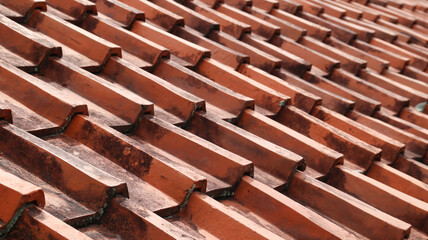 Clay tile roof. Banner with orange clay tile roof close-up on blue sky background with space for text, copy space