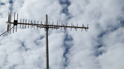 UHF Television antena with blue sky and clouds background