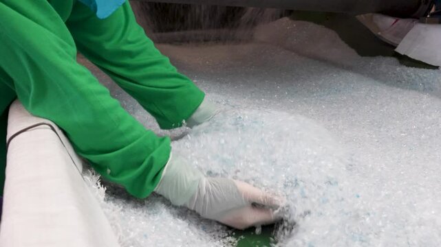 How recycled plastic is processed into usable fibers with detailed close up shots from a modern recycling facility.