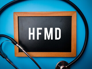 Statehoscope and wooden board with the word HFMD on a blue backgorund