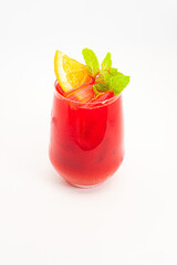 vibrant red berry cocktail with orange slice and fresh mint leaves served in clear glass with ice on white background. High quality photo