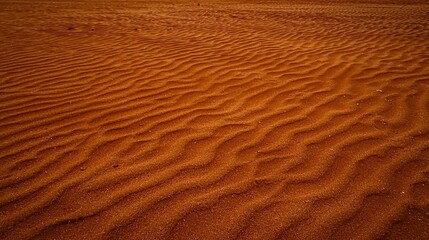 Detailed view of a textured red sand surface.