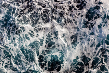 Sea water background. Top view of vibrant foamy water. Can be used in covers, packaging, posters, textures, presentations, art and design projects. Amazing nature background image.